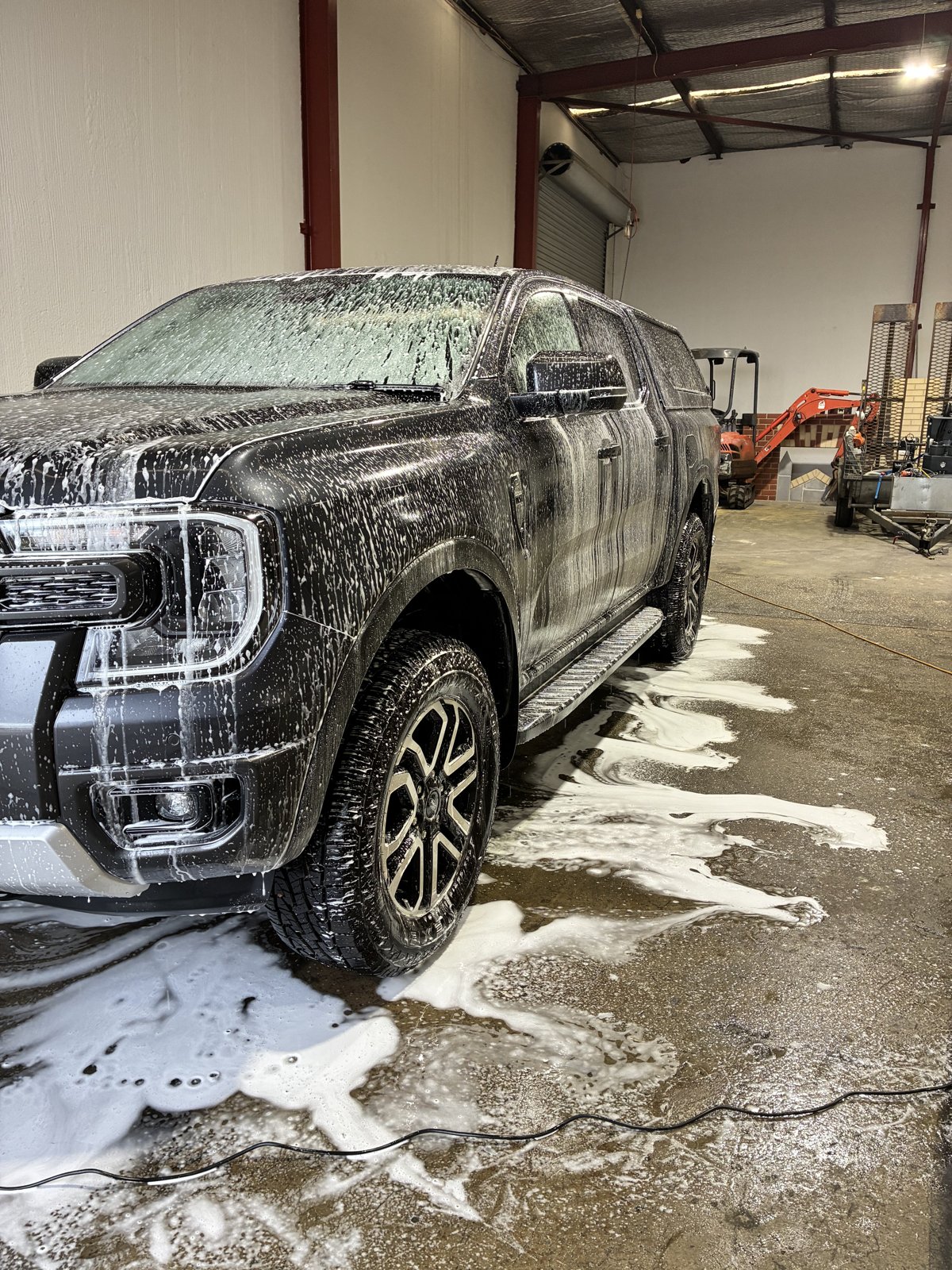 Car being hand washed with soap suds